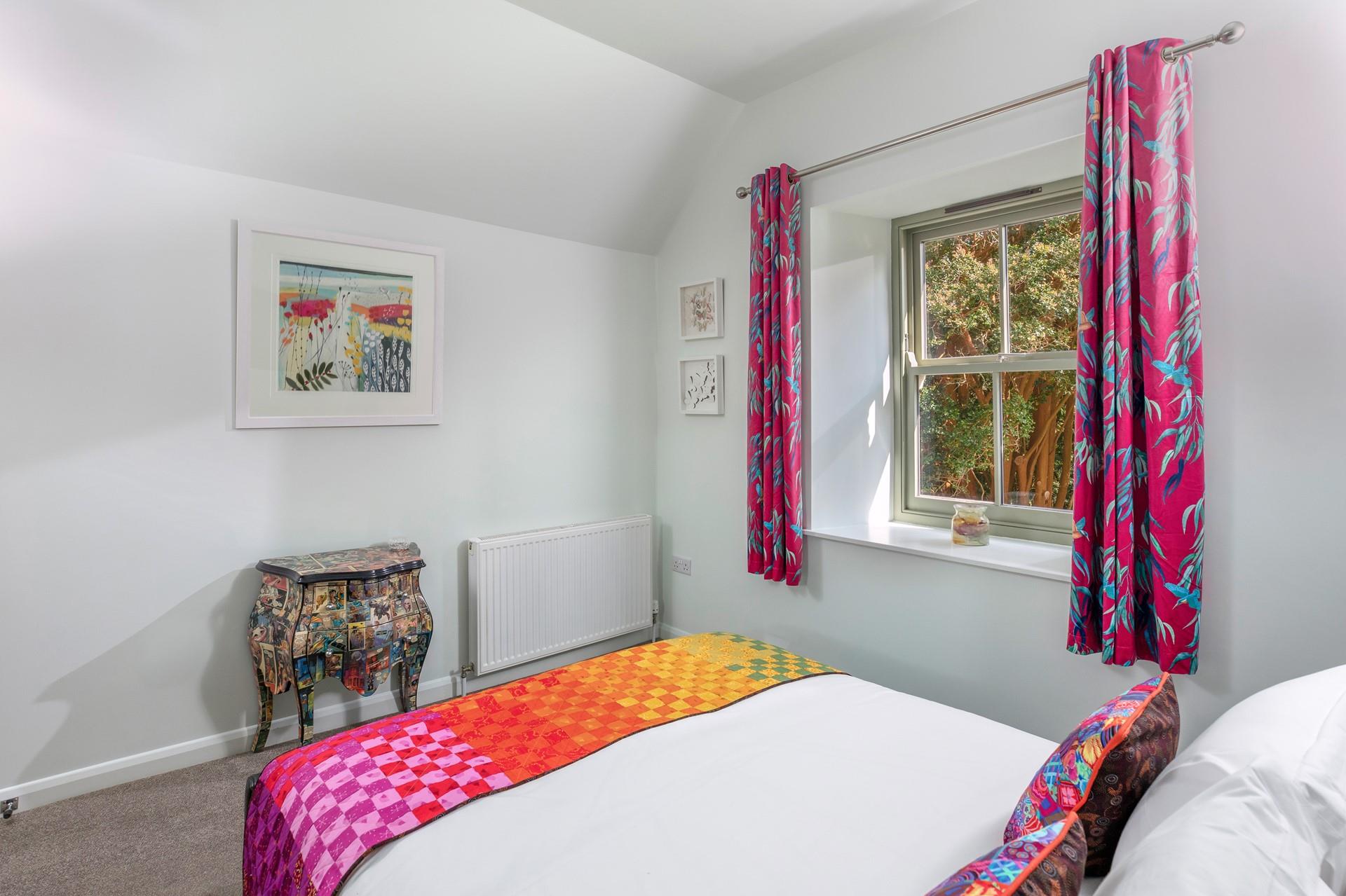 A light and bright bedroom where you'll sleep soundly surrounded by nature.