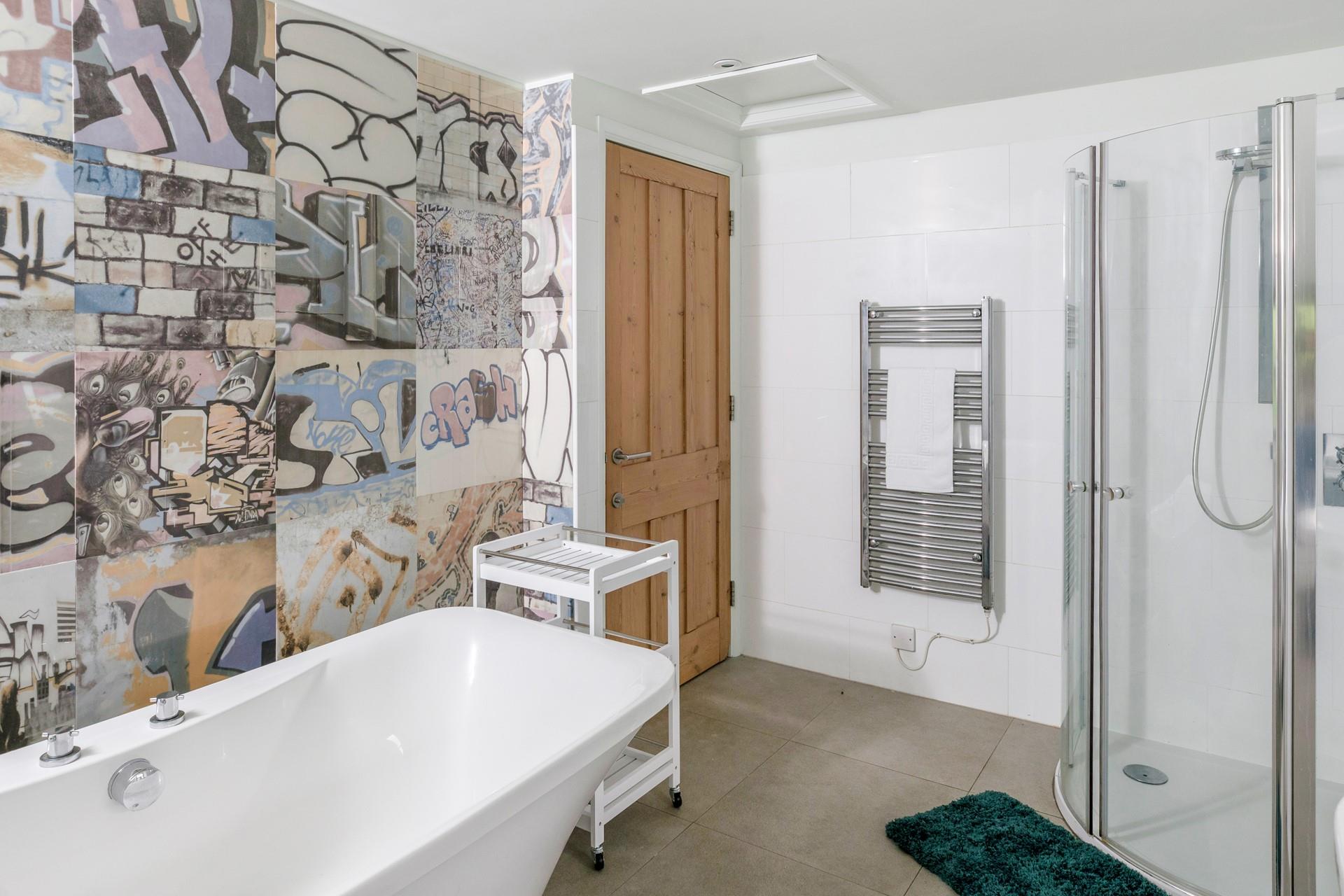 The family bathroom has plenty of space, with a freestanding bath and walk-in shower.