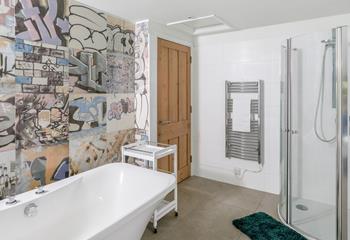 The family bathroom has plenty of space, with a freestanding bath and walk-in shower.