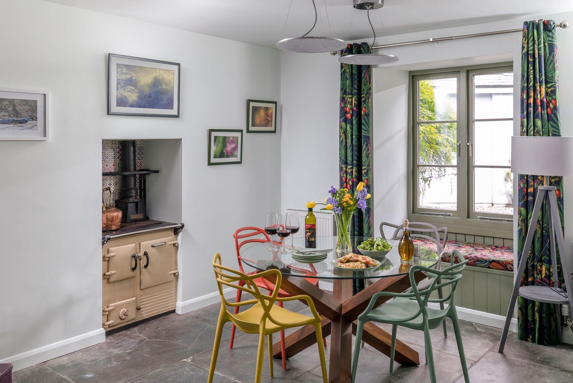 The dining space is bright and spacious with botanical decor reflecting the beautiful cottage gardens.