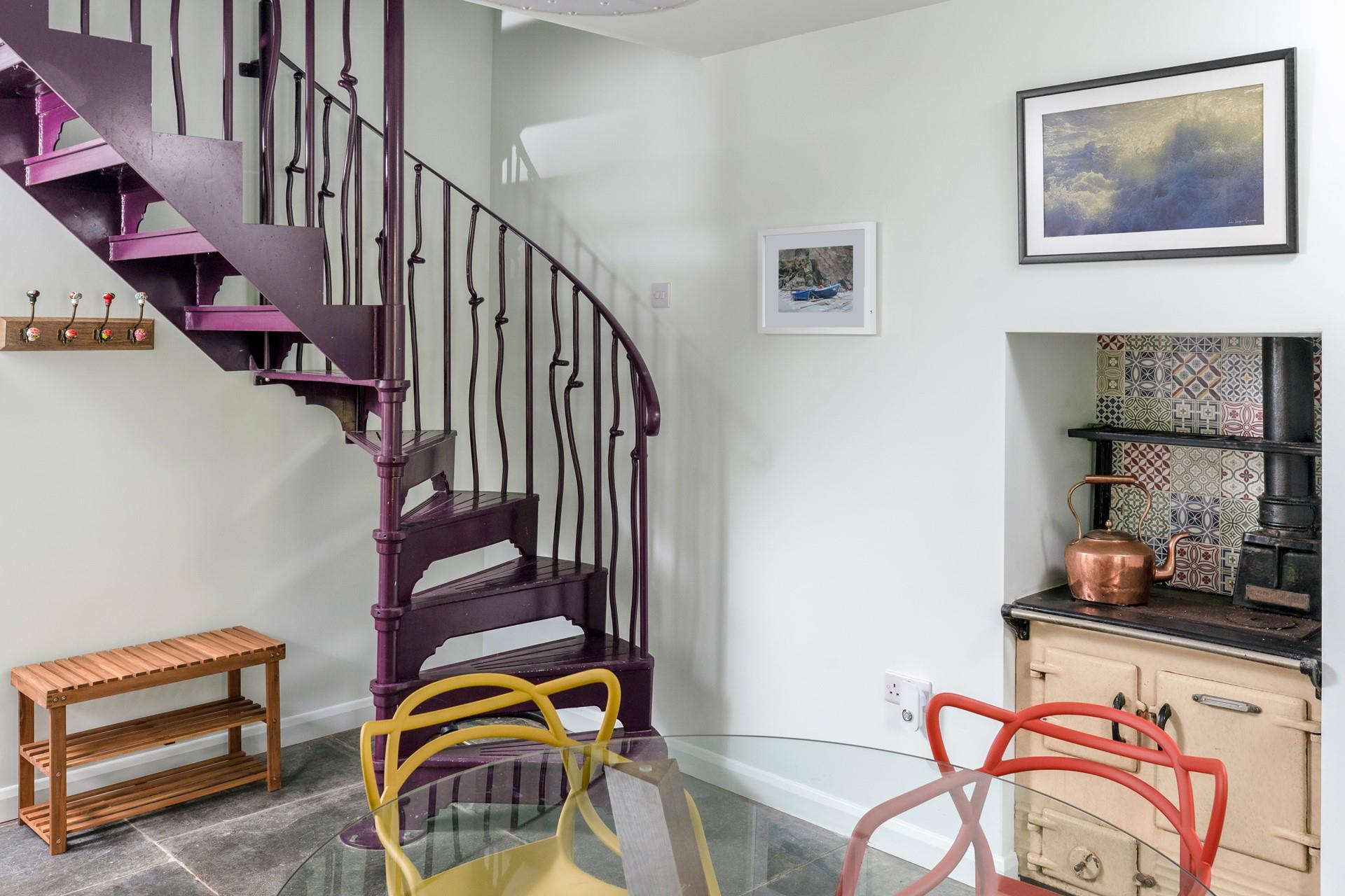The spiral staircase is a vibrant feature in the dining room.