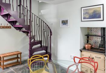The spiral staircase is a vibrant feature in the dining room.