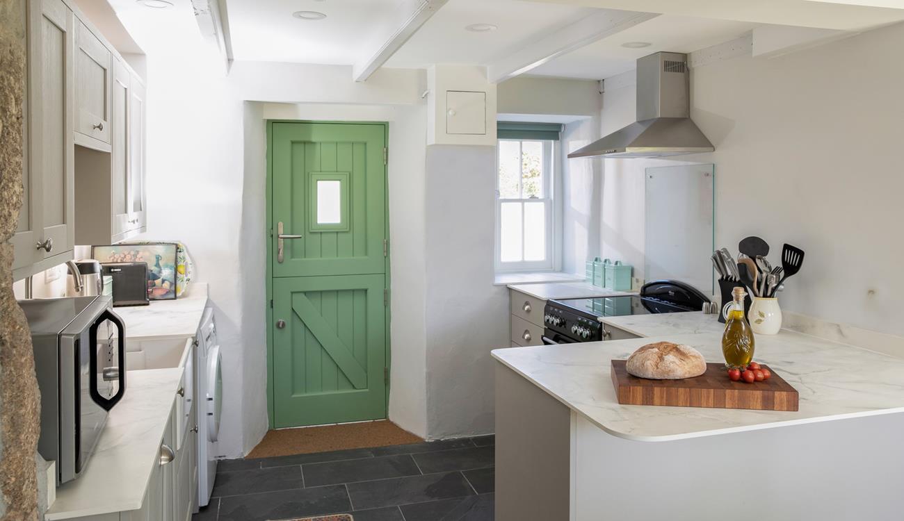 The kitchen is modern with plenty of worktop space.