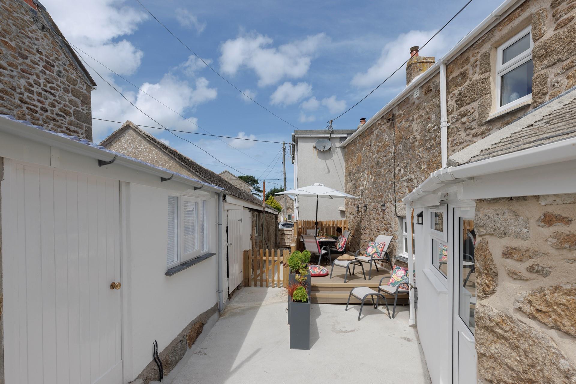 Take a morning stroll to the harbour in Mousehole and return to the sunny garden.