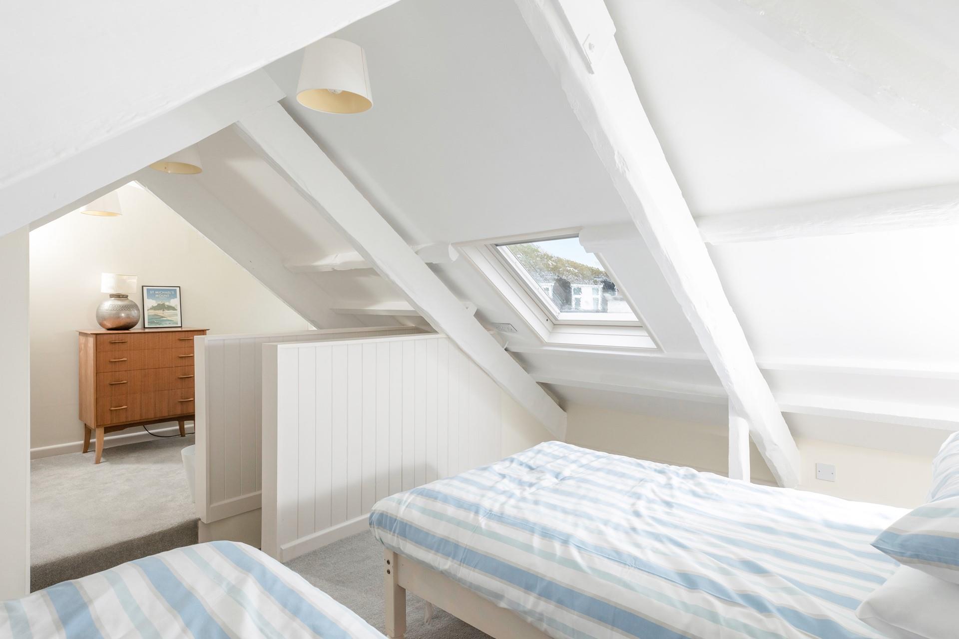 Bedroom 3 is located upstairs and has beautiful sea views.