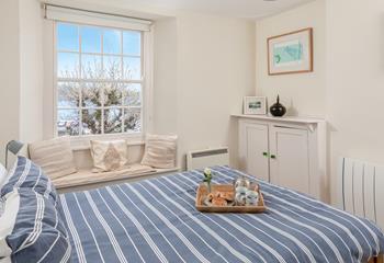 Bedroom 1 has sea views through the trees.