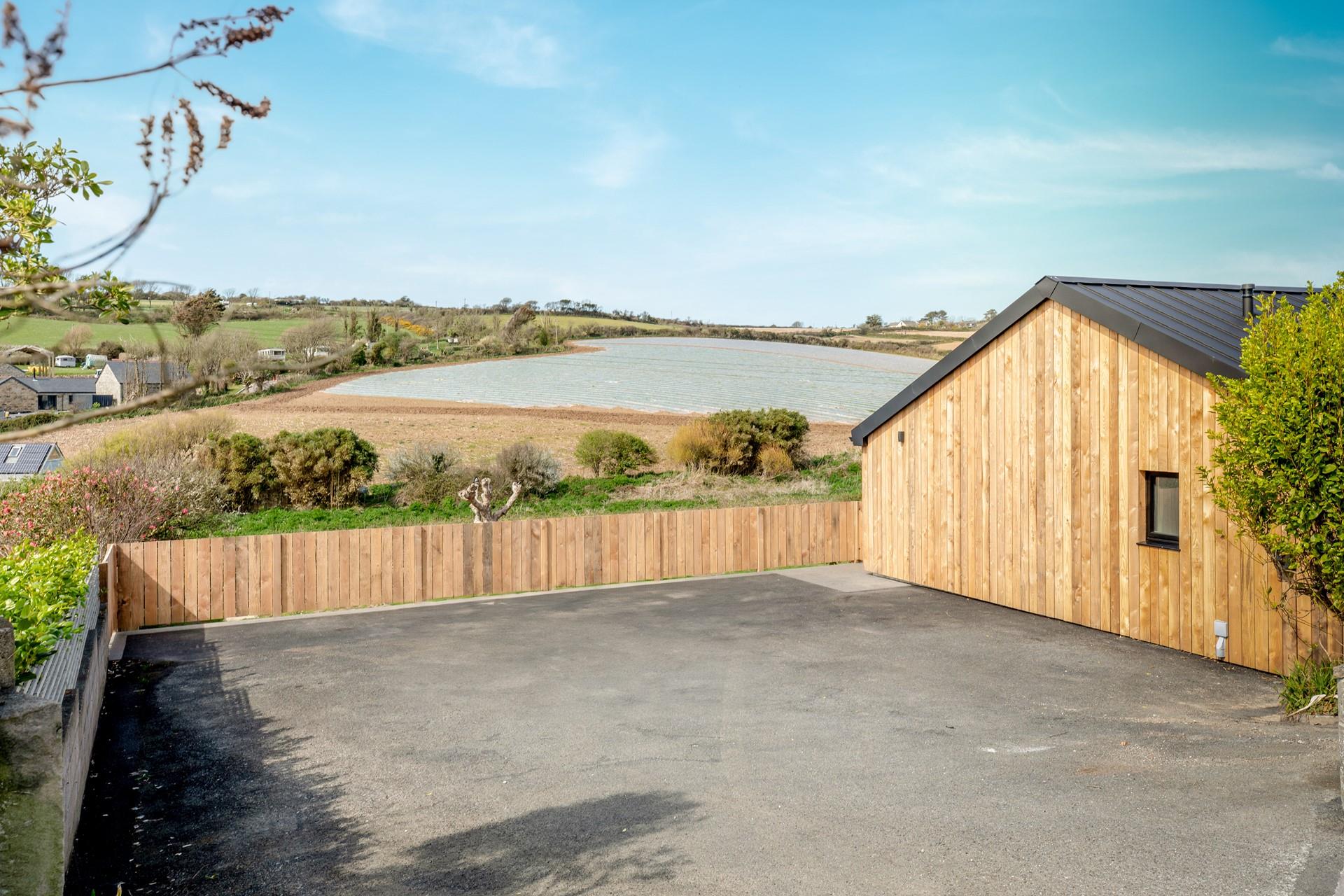The parking area can fit up to 4 cars, with EV charging point.