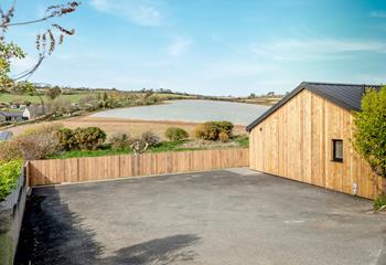 The parking area can fit up to 4 cars, with EV charging point.