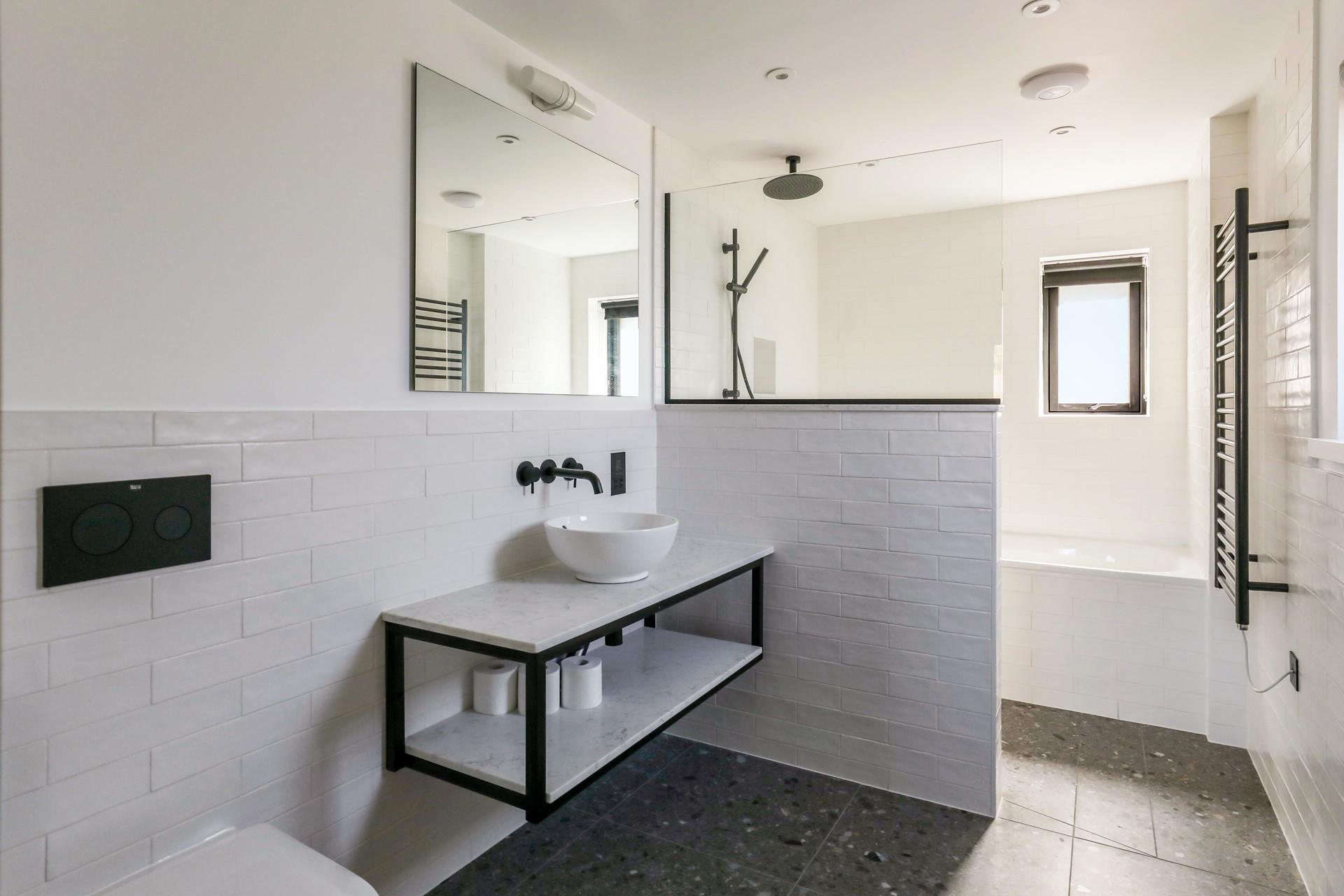 The bathroom has a separate shower head for washing sandy toes.