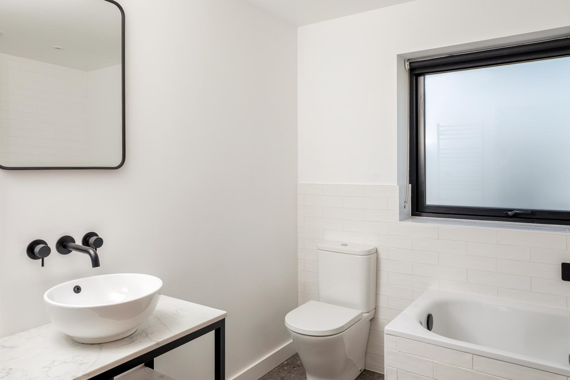 Wash off the sand in the family bathroom.