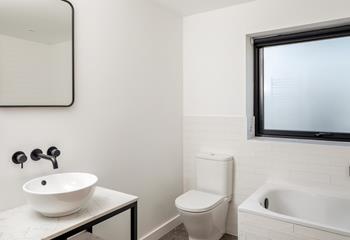 Wash off the sand in the family bathroom.