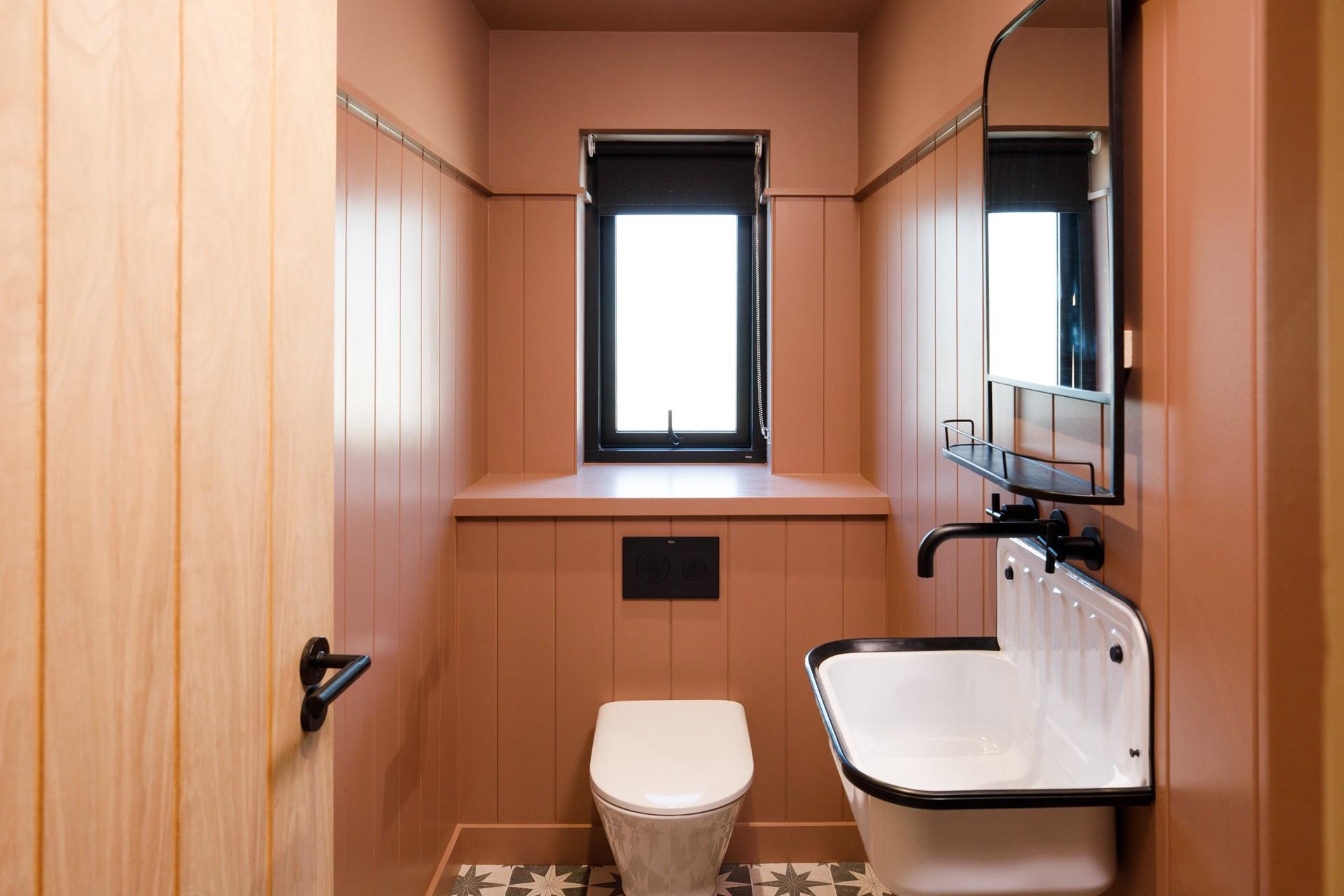 We love the pink colour drenching in the cloakroom!