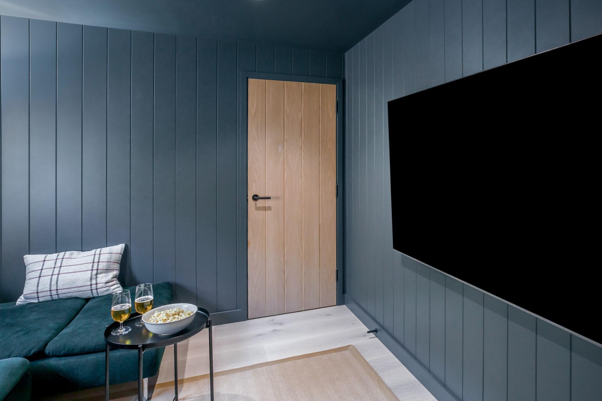 Sip a cold beer and dig into popcorn in the cinema room.