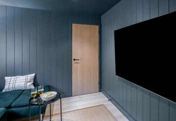 Sip a cold beer and dig into popcorn in the cinema room.