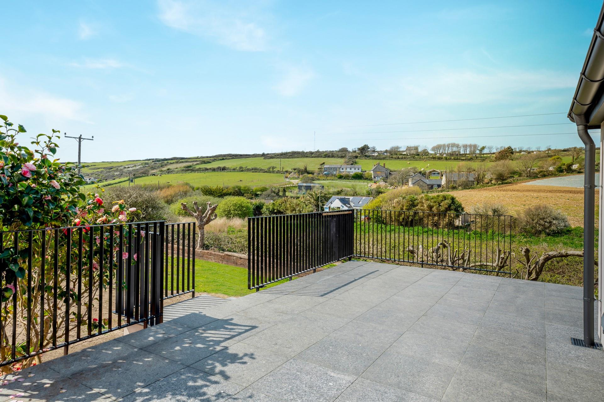 The large garden features a terrace and a lawned area.