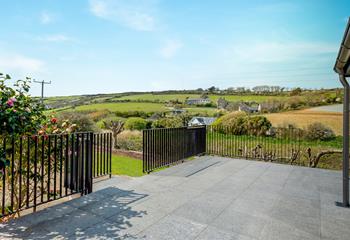 The large garden features a terrace and a lawned area.