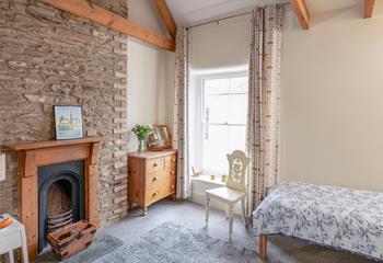 Bedroom 2 has twin beds and a feature fireplace.