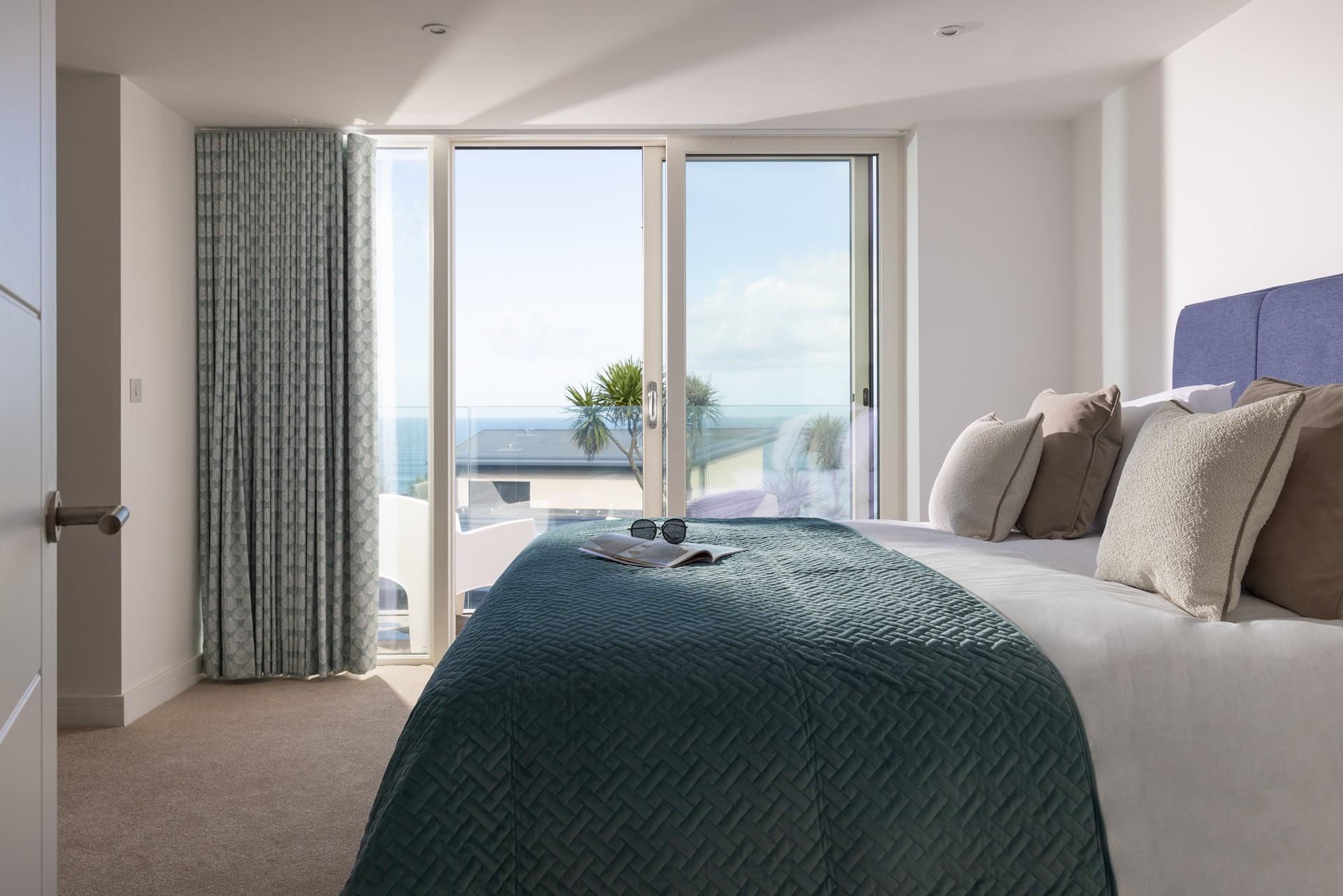 Step from the opulent king size bed onto the sea-facing balcony.