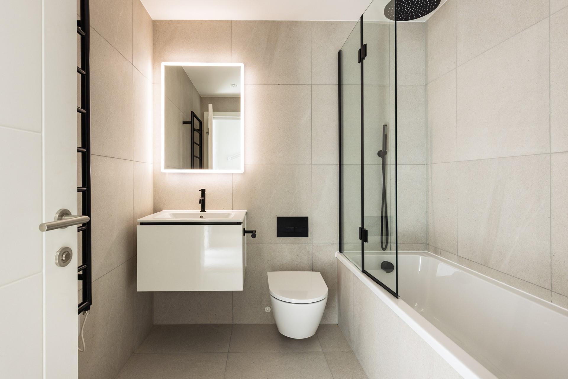 The modern family bathroom benefits from a rainfall shower over bath.