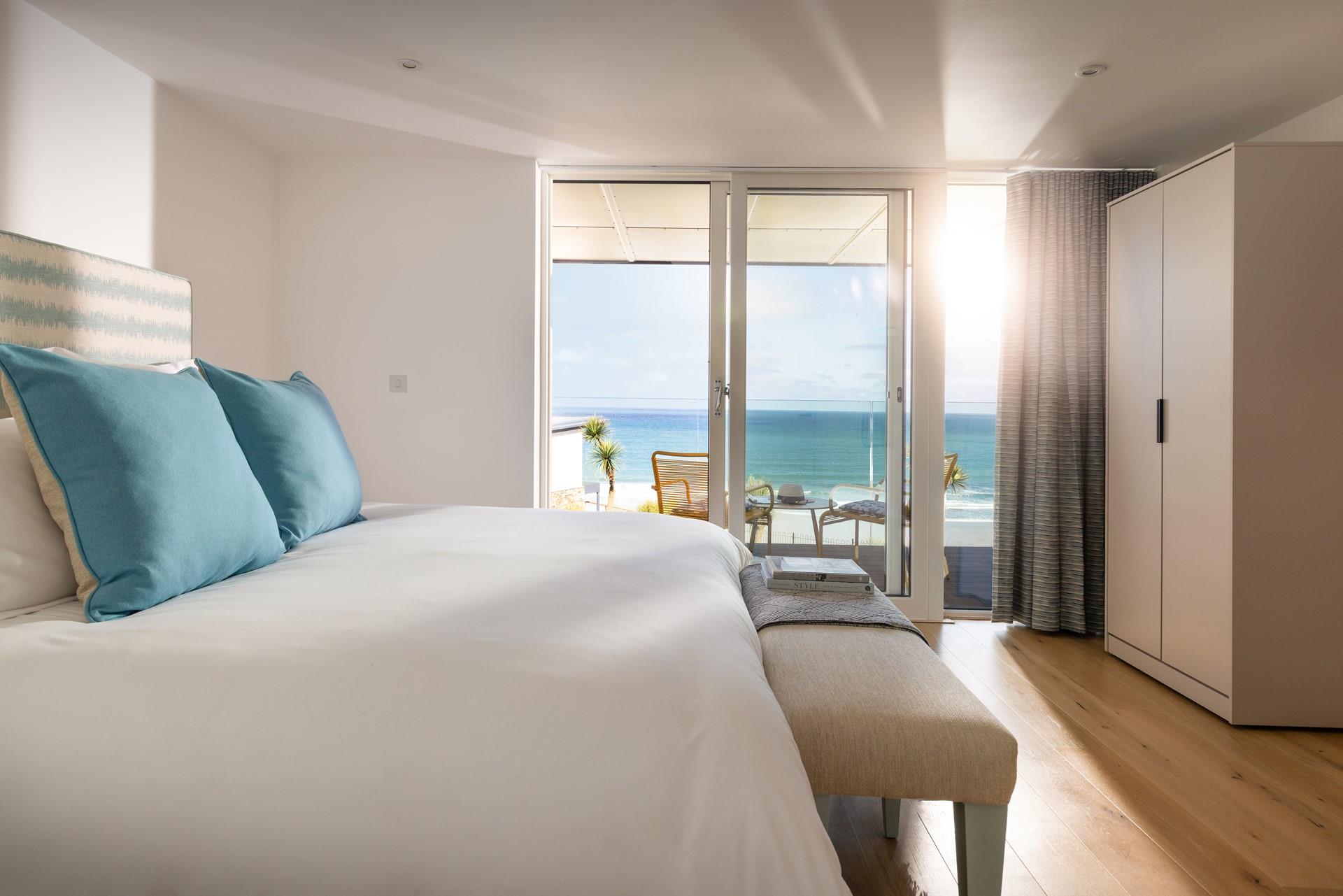 Bedroom 1 benefits from ocean views and modern decor.