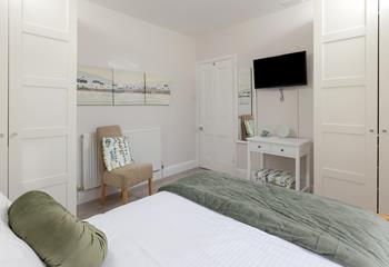 The bedroom is decorated with calming colours for a relaxing night's sleep.