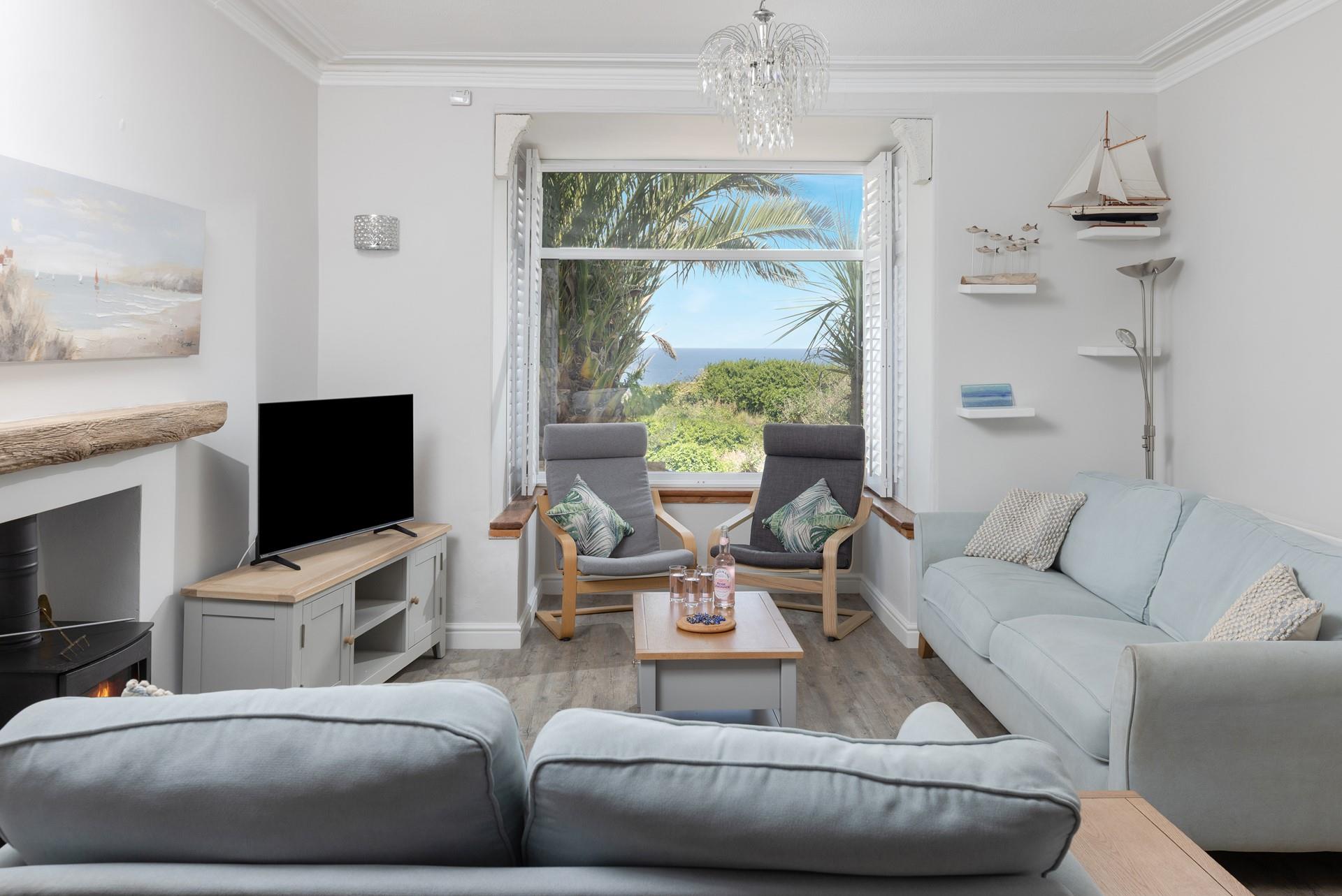 Enjoy sea views from the cosy sitting room at Trevarno.