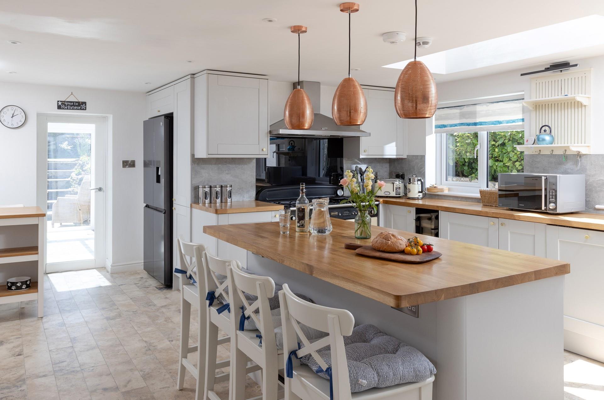 The kitchen is modern and spacious, featuring an island and plenty of worktop space.
