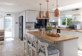 The kitchen is modern and spacious, featuring an island and plenty of worktop space.