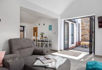 The light and airy living space has ample room with direct access to the garden.
