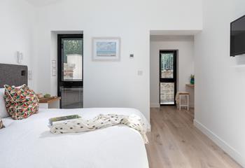 A modern dressing area is tucked around the corner.