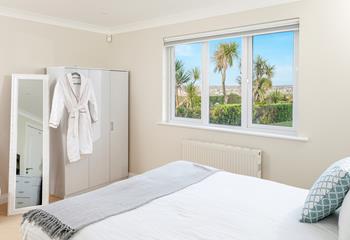 Soft sheets and robes await in the peaceful bedrooms.