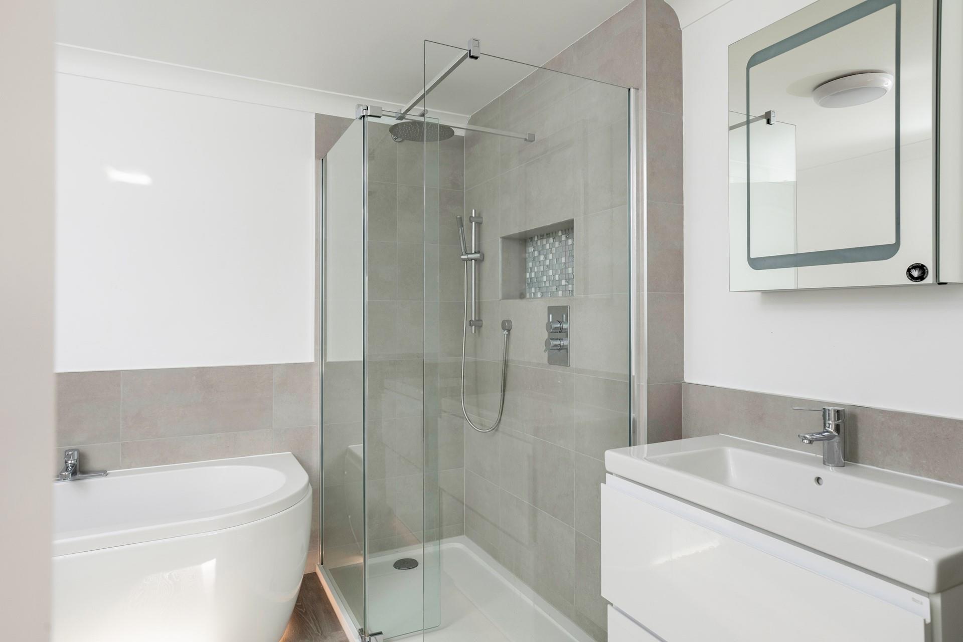 Wash the day away in the sleek and modern en suite.