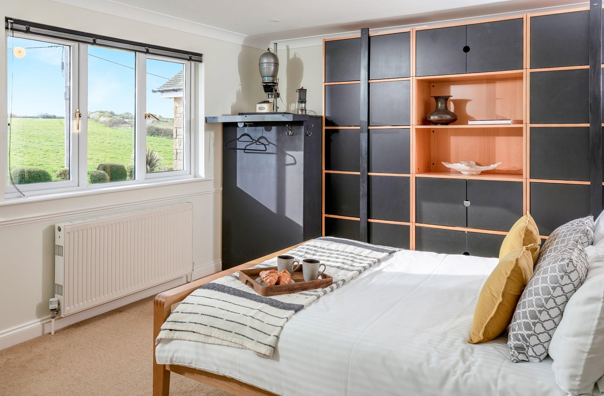 The upstairs bedroom has tranquil countryside views.