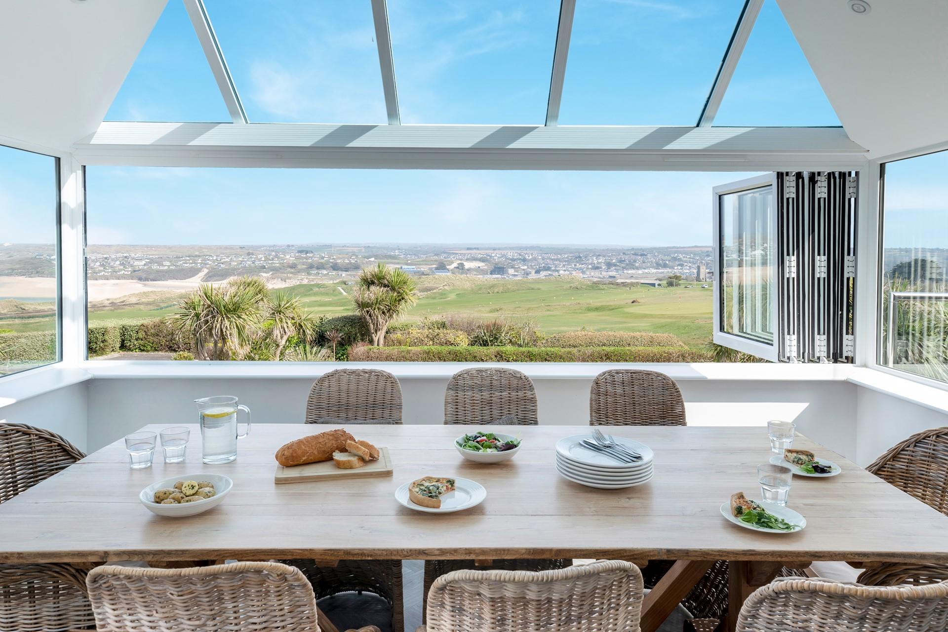The dining area takes advantage of the views across the golf club and beach.