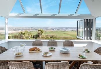 The dining area takes advantage of the views across the golf club and beach.