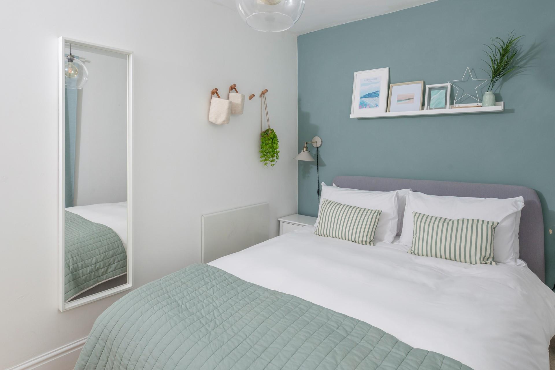 Calming greens greet guests in bedroom 1.
