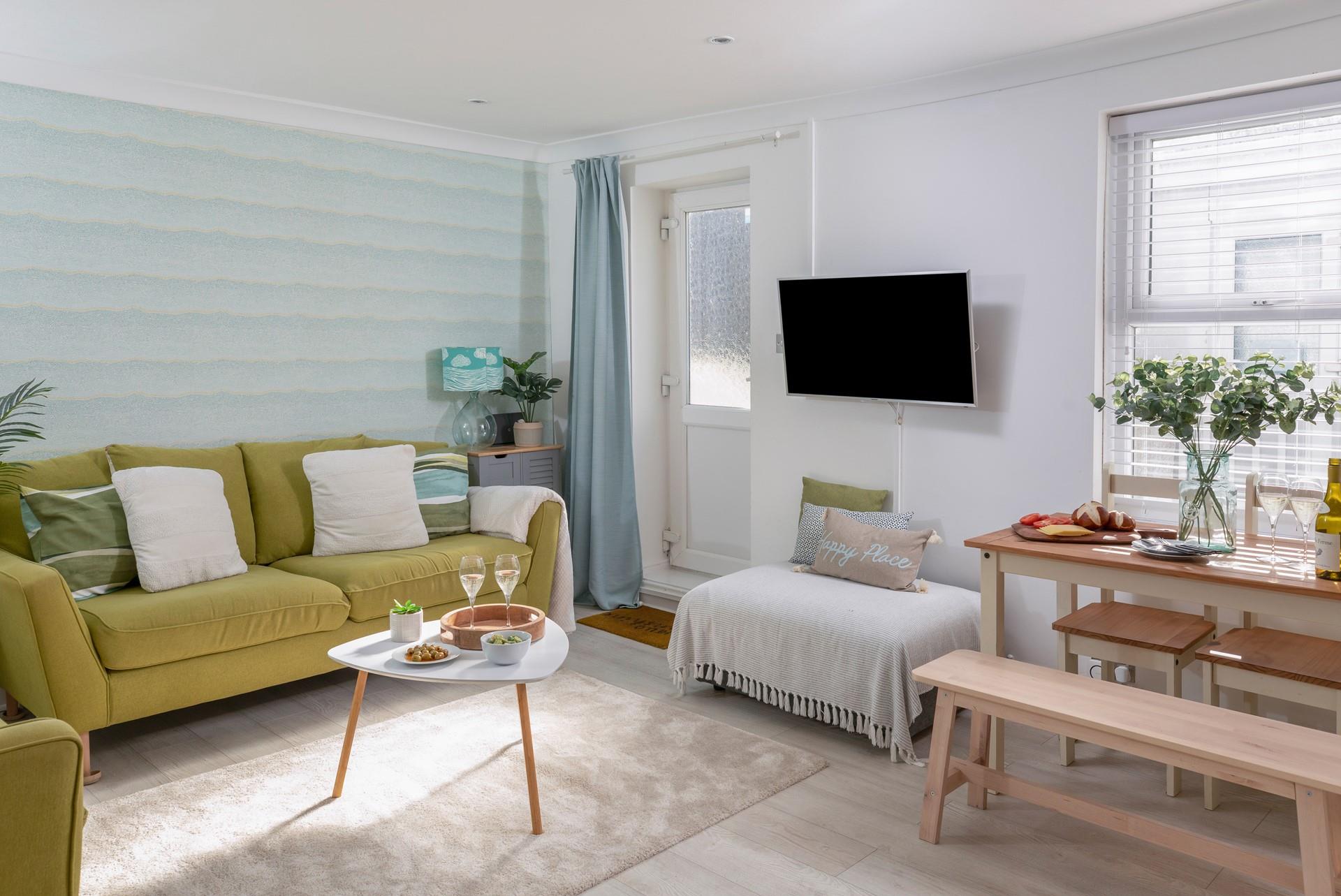 This bright and colourful sitting room is the perfect base to return to after exploring St Ives.