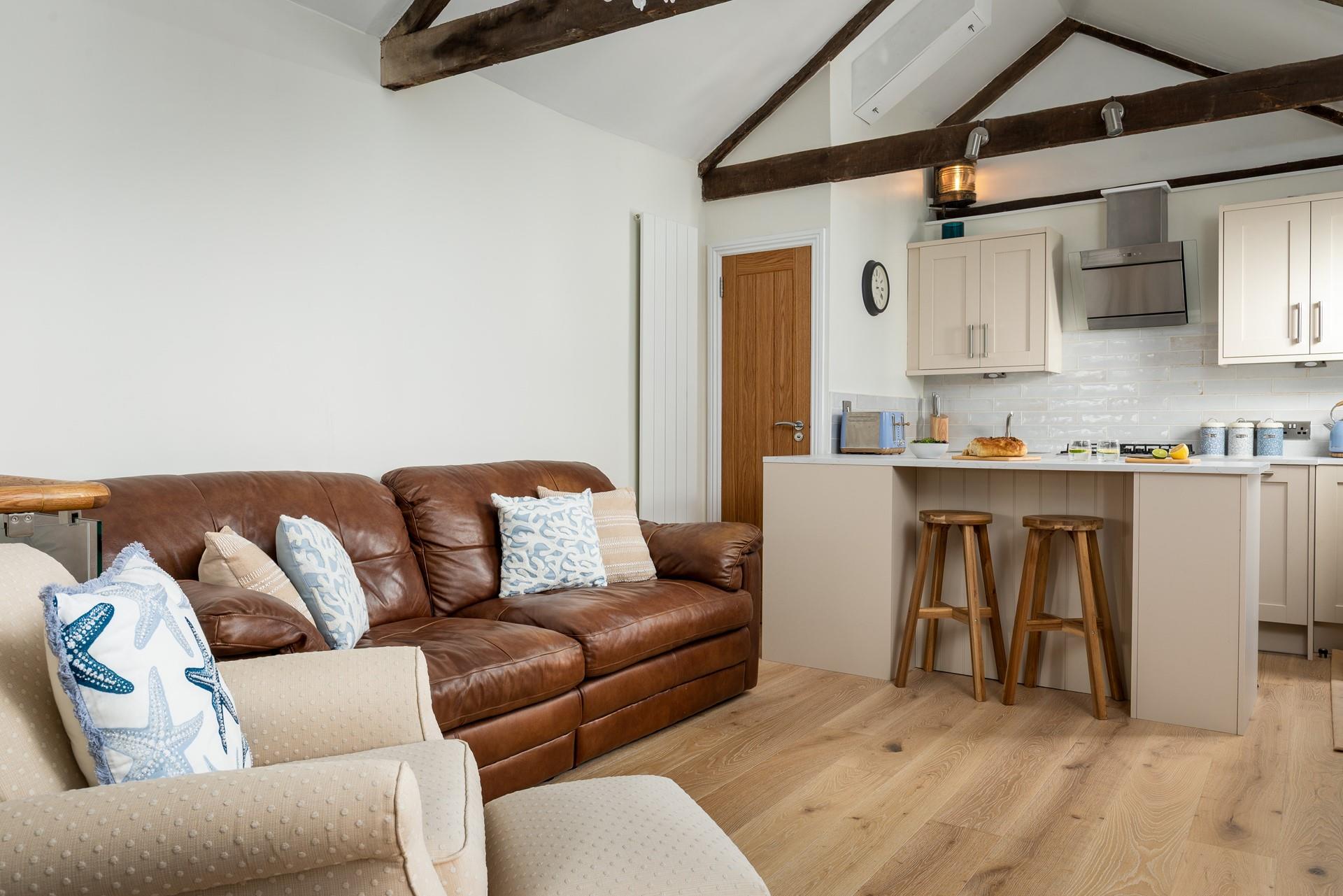 The open plan living space is stylishly decorated, keeping its traditional cottage features.