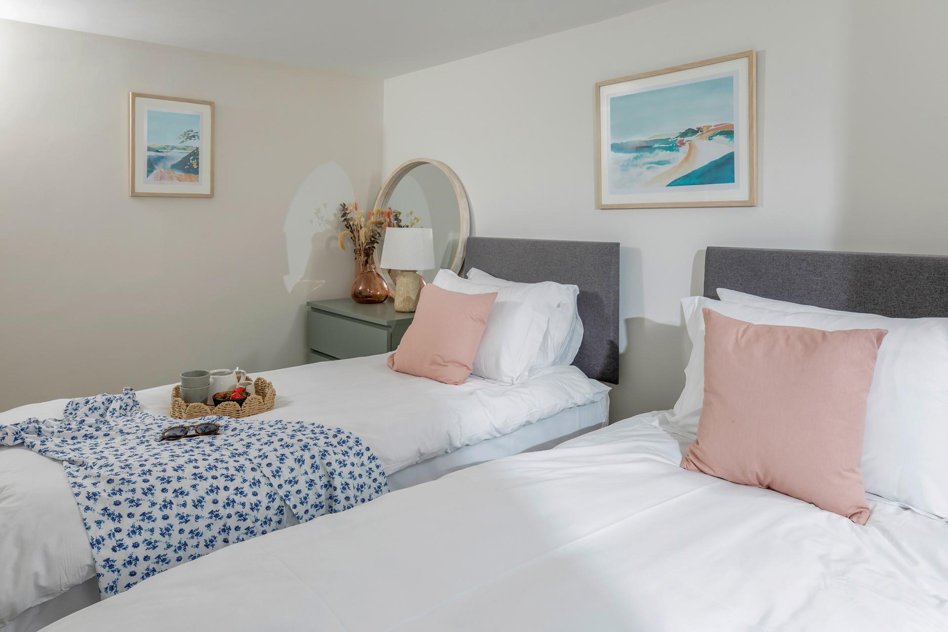 The bedrooms are stylishly decorated with pastel tones.
