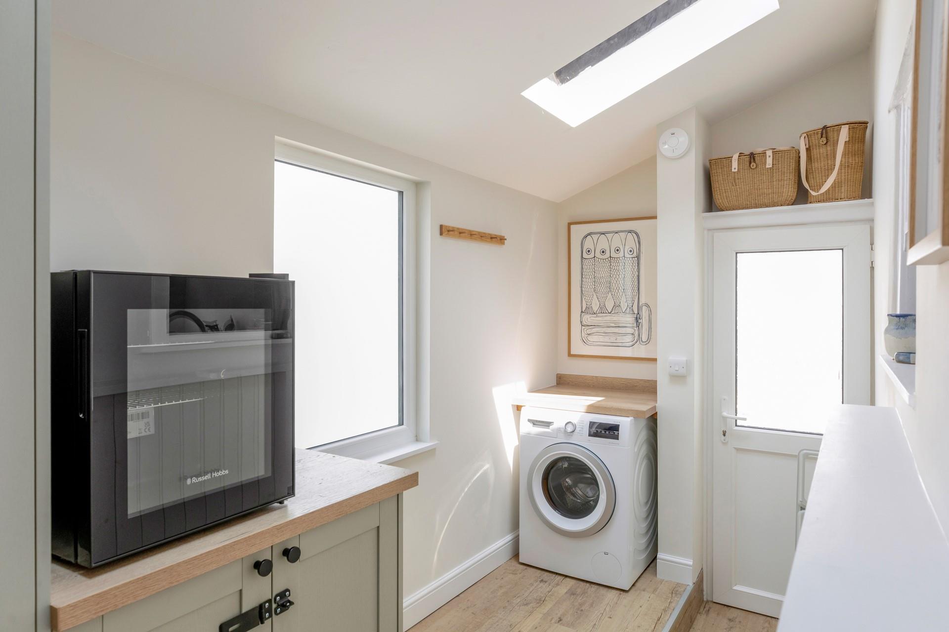 There is a handy washing machine and utility area.