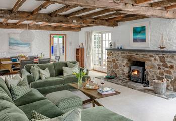 Quirky and characterful, the sitting room has exposed beams and a woodburner.
