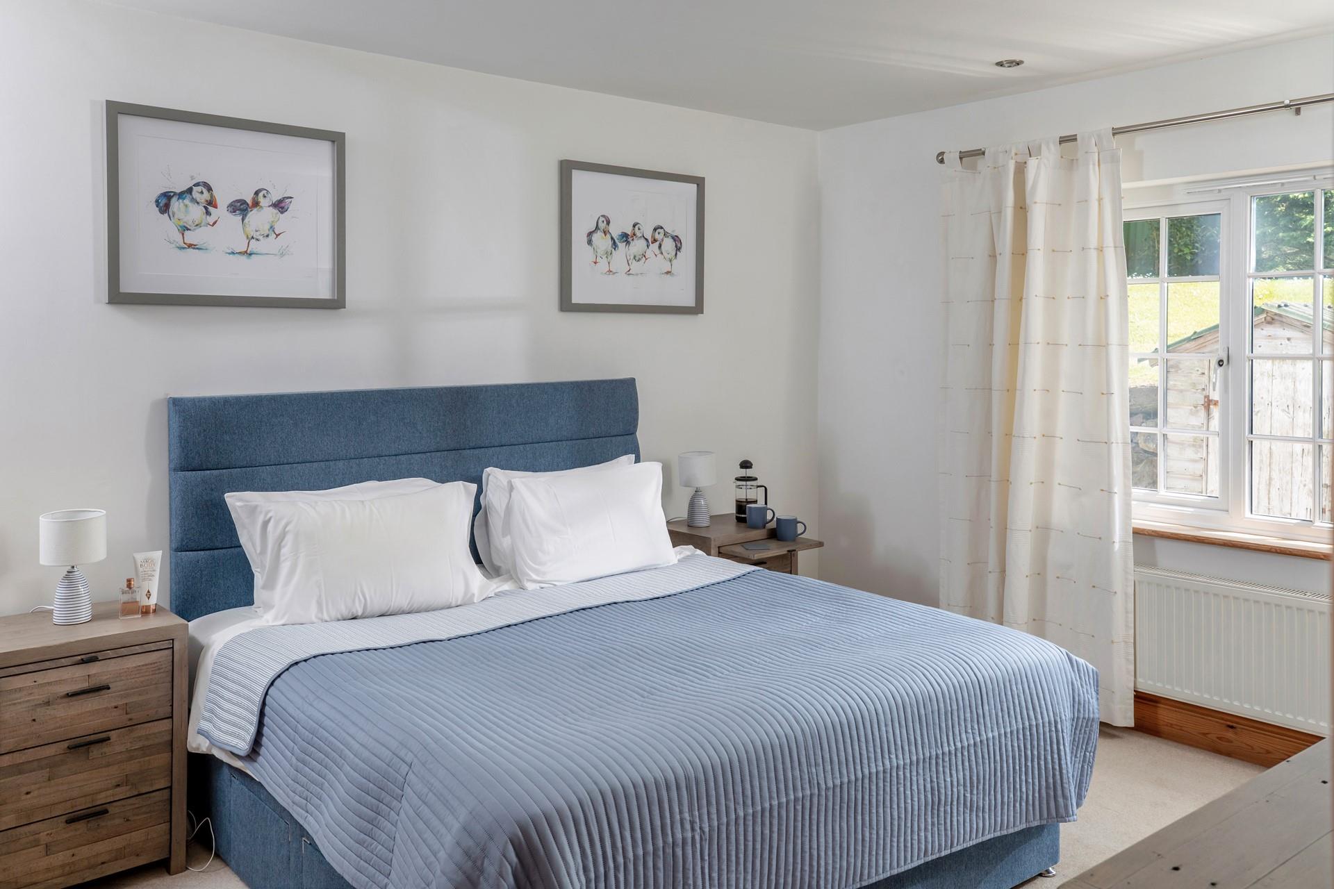 The spacious king size bed offers a relaxing slumber.