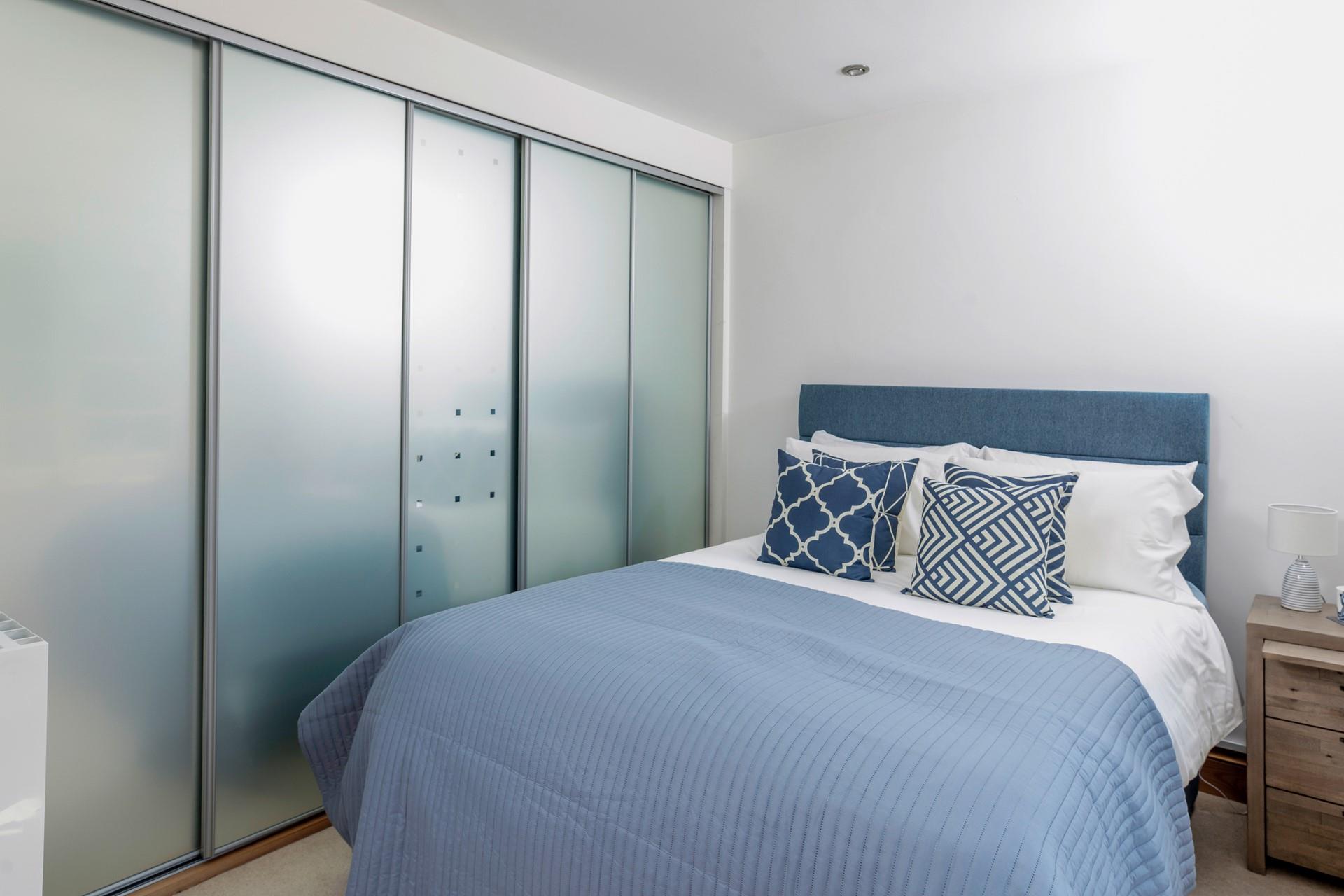 Bedroom 2 has a king-size bed and a built-in wardrobe.