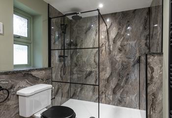 The bathroom has a large walk in shower with a rainfall head.
