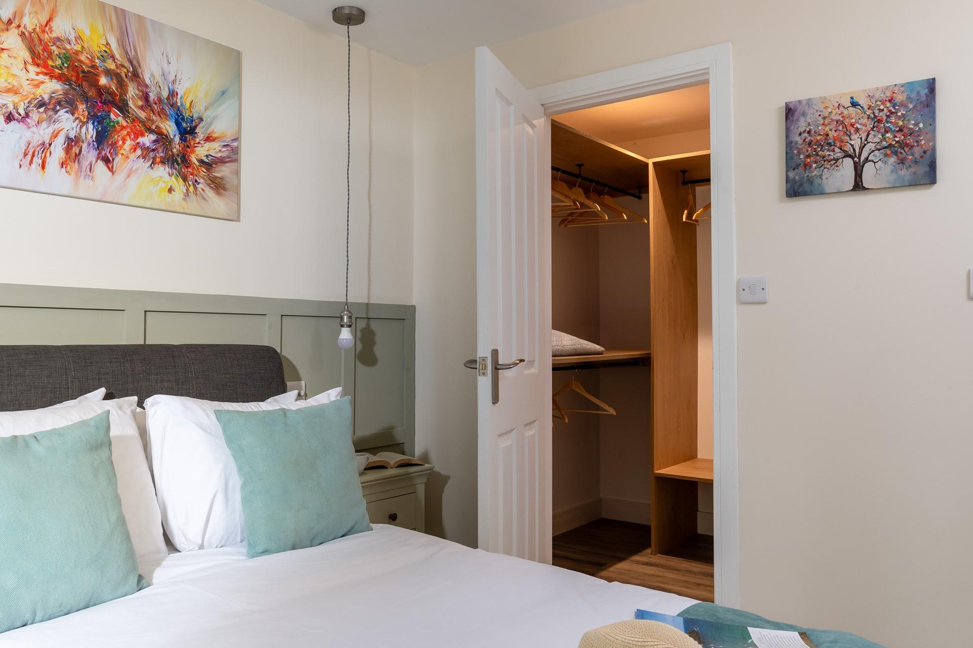 The bedroom boasts a large walk-in wardrobe.