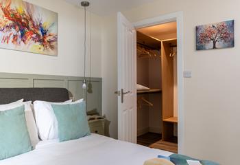 The bedroom boasts a large walk-in wardrobe.