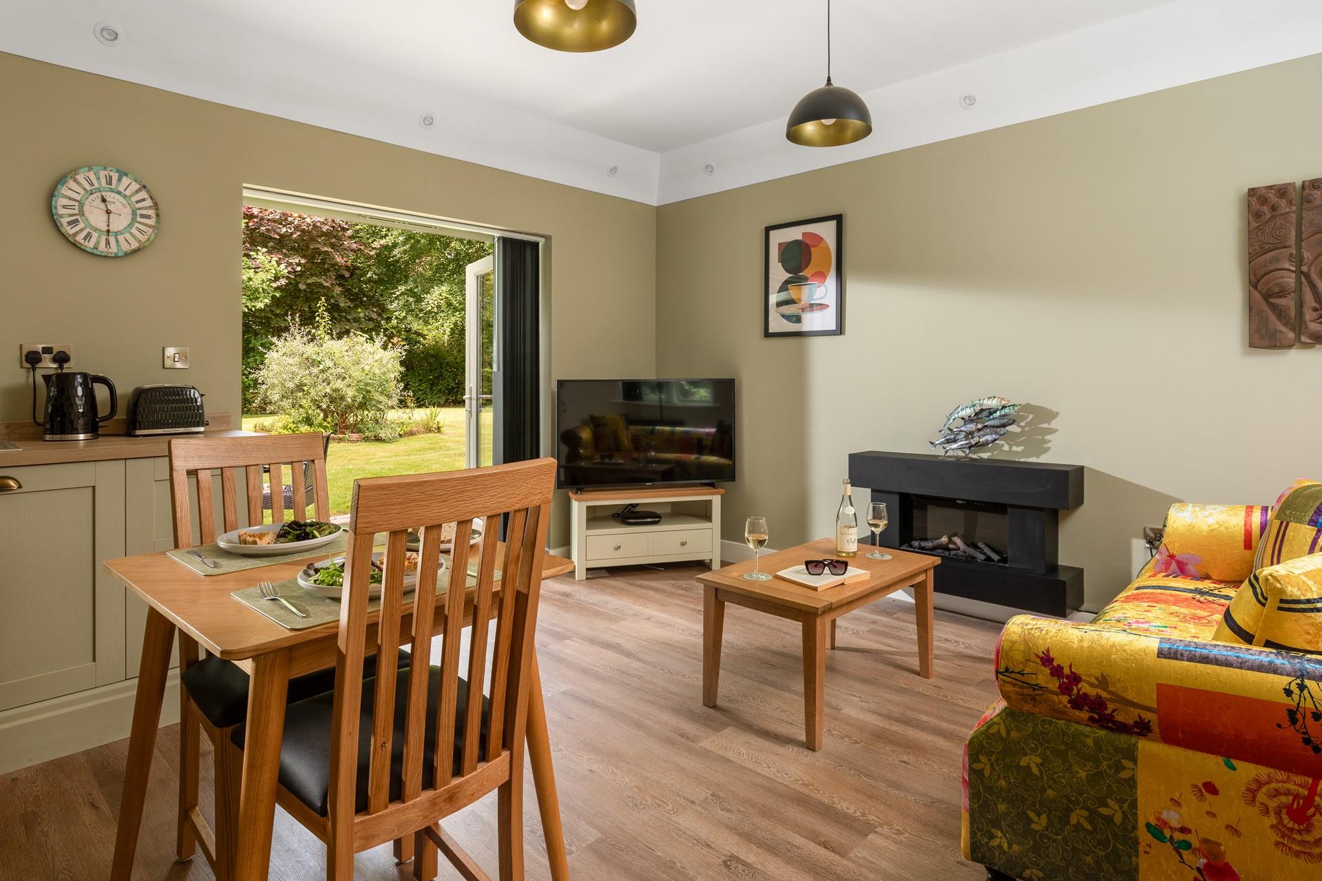 Open plan living with doors into the pretty garden.