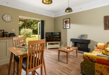 Open plan living with doors into the pretty garden.