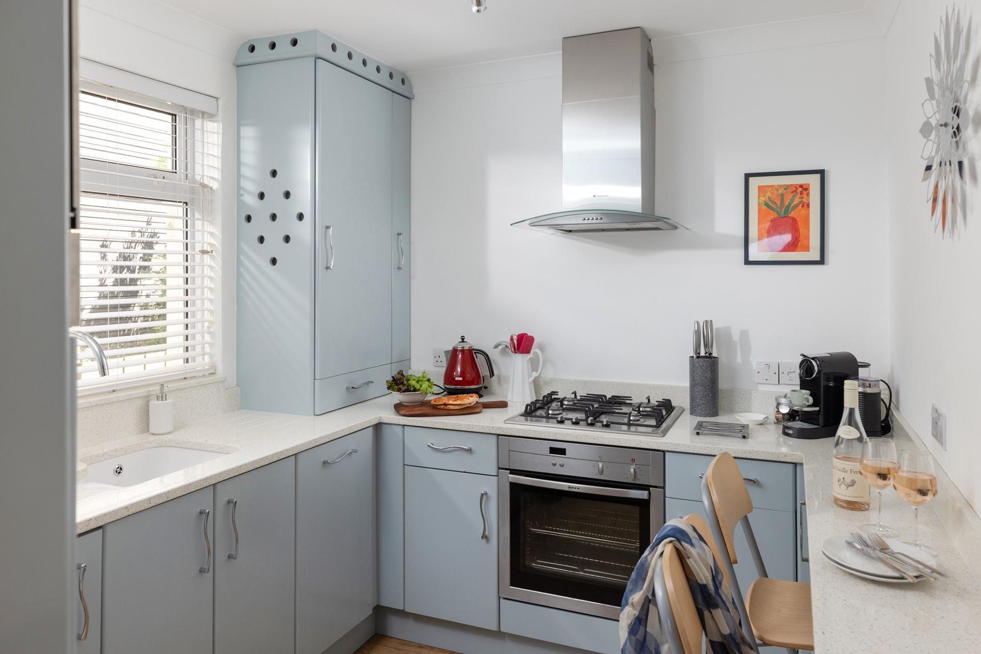 The kitchen has all the appliances needed to prepare and cook meals.