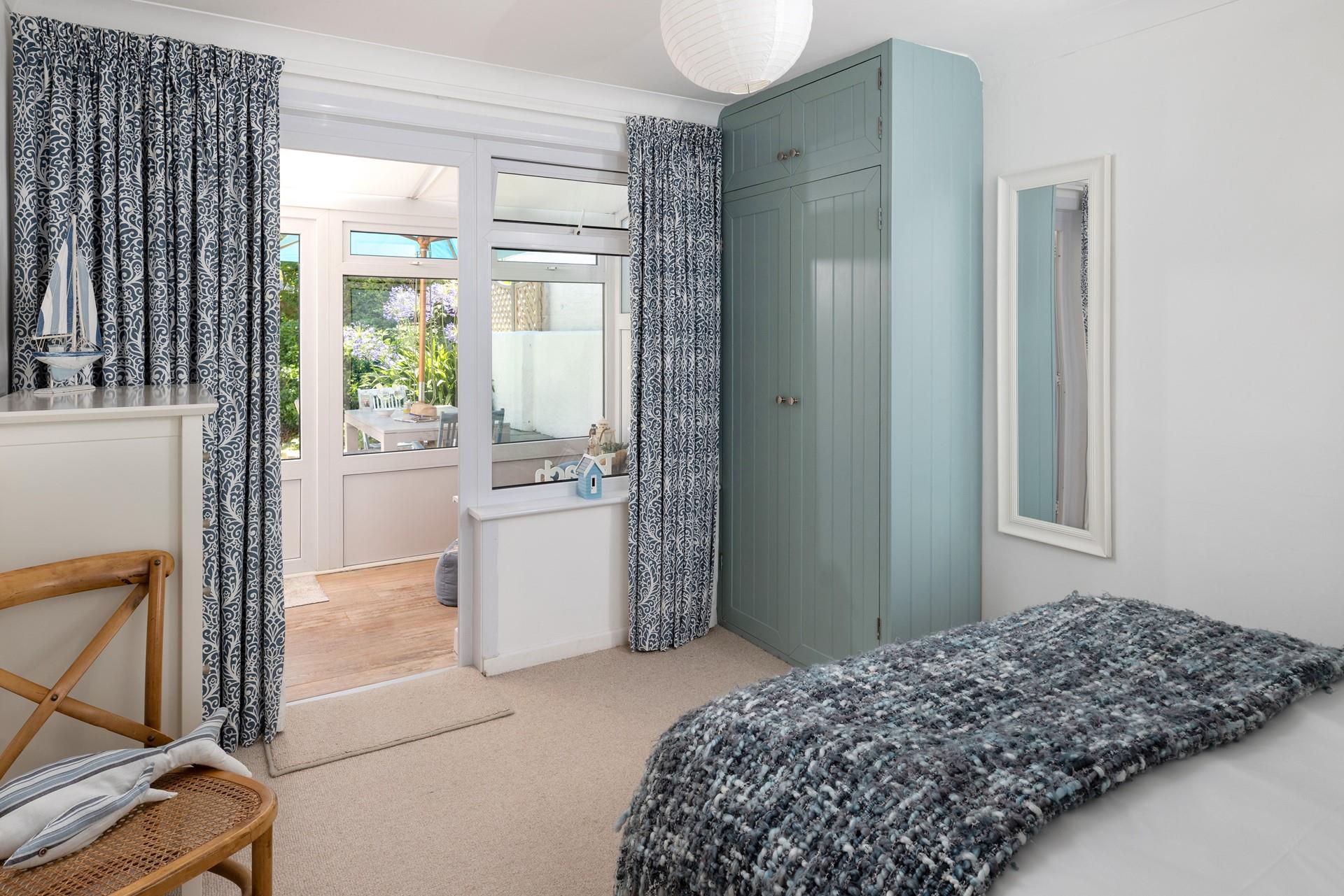 The bedroom leads out to the conservatory area, perfect for a morning cuppa.